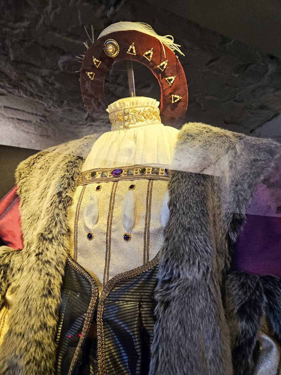 Luxurious clothing on display in the castle vaults depicting outfits worn by the king - a visit to Stirling castle is one of the best things to do in Stirling with kids