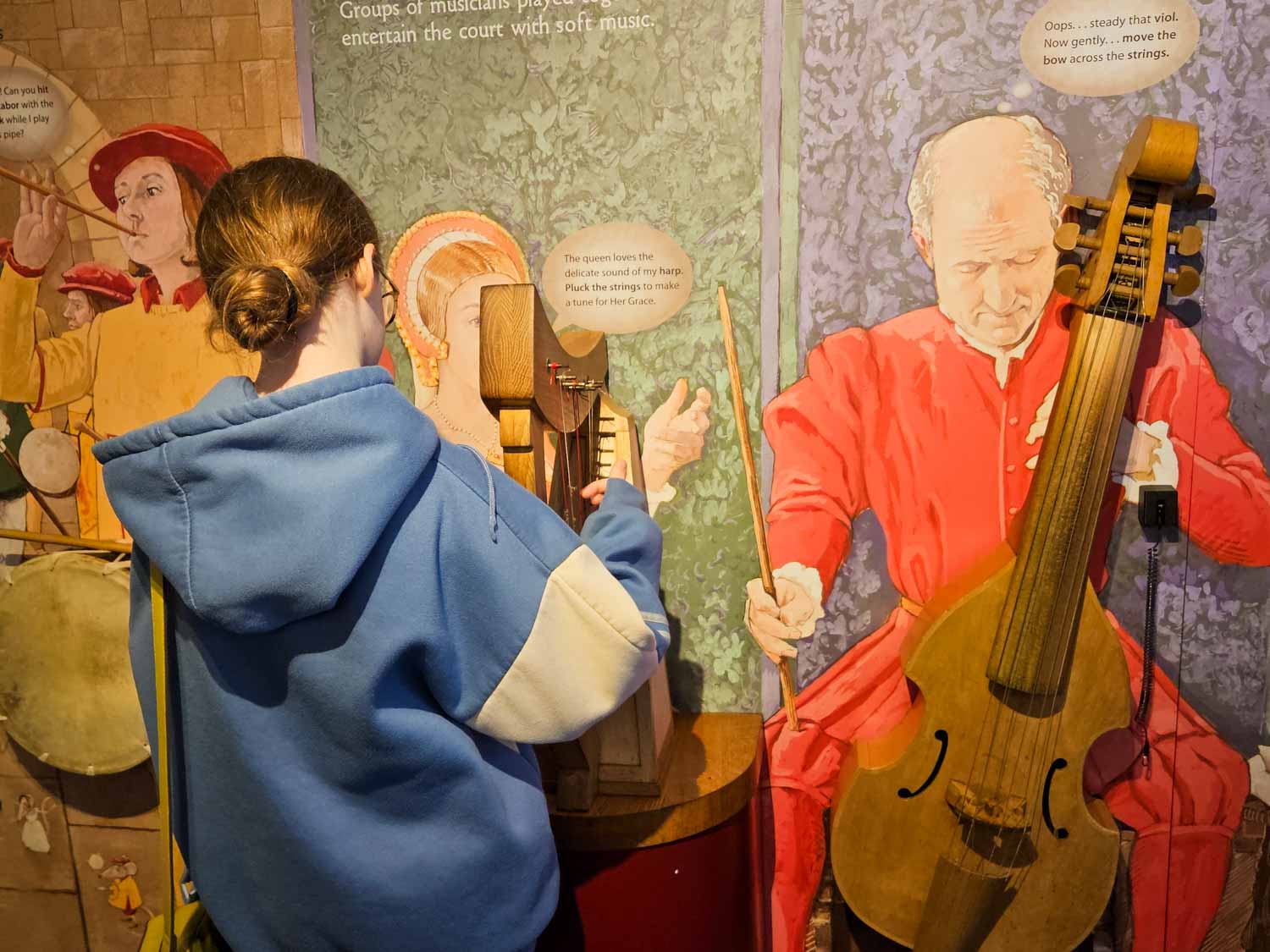 My daughter looks at some of the musical instruments in the vaults - a visit to Stirling castle is one of the best things to do in Stirling with kids