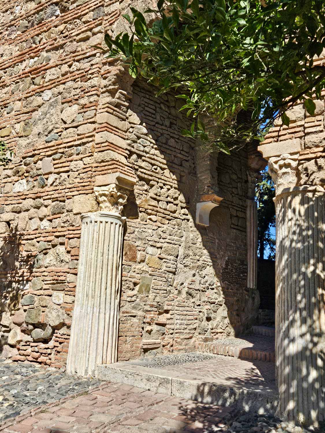 Roman pillars built into the arch of the Alcazaba, the Muslim palace fortress in Malaga - a visit is one of the best things to do in Malaga with children