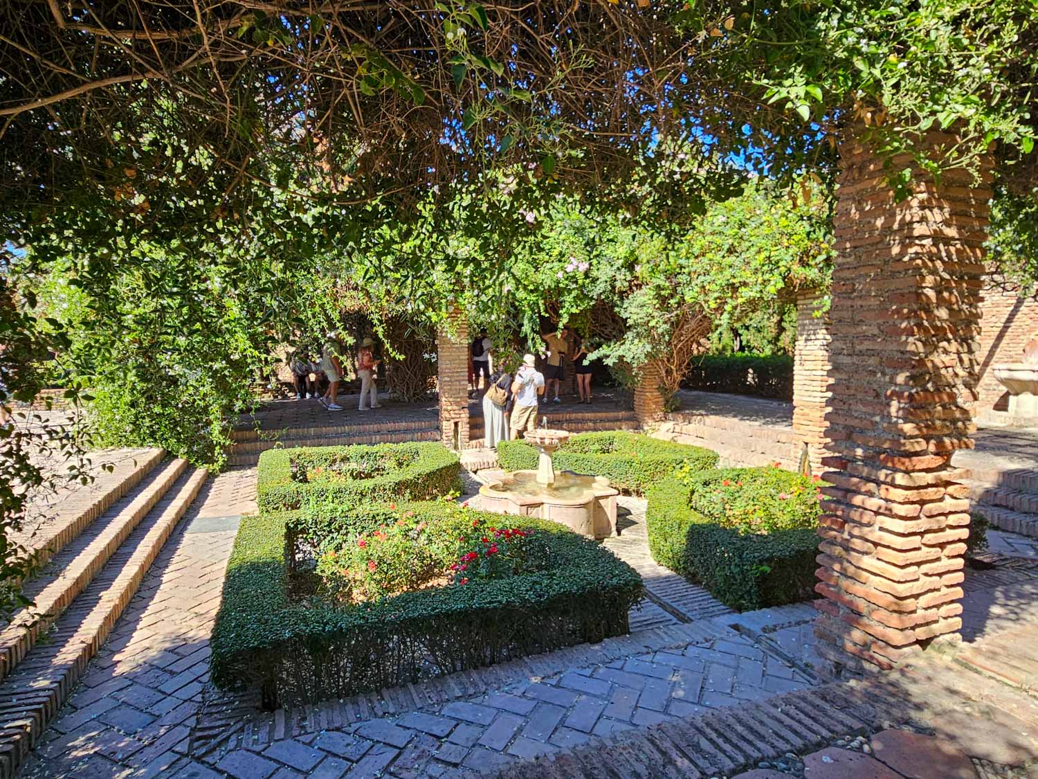 Courtyard with rose bushes inside the Alcazaba palace-fortress in Malaga - a visit is one of the best things to do in Malaga with kids