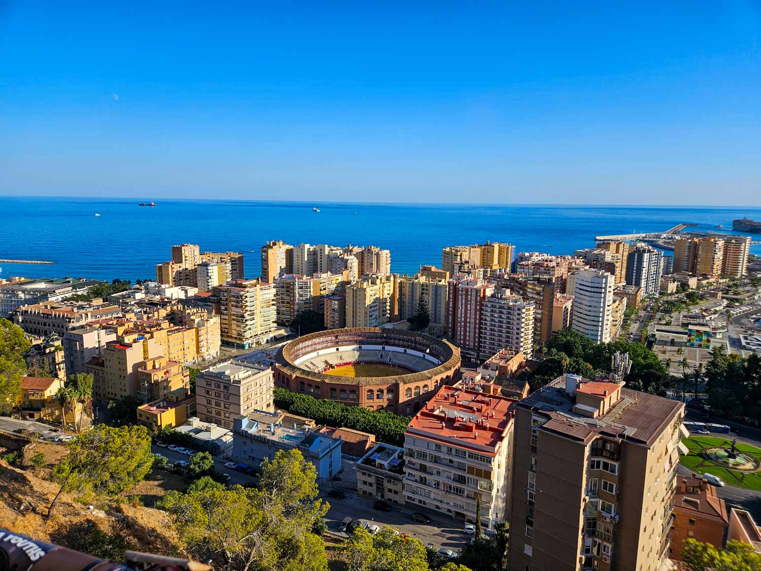 View down onto the bull ring and high rise buildings of Malaga with the sea beyond - my tips on the best things to do in Malaga with kids