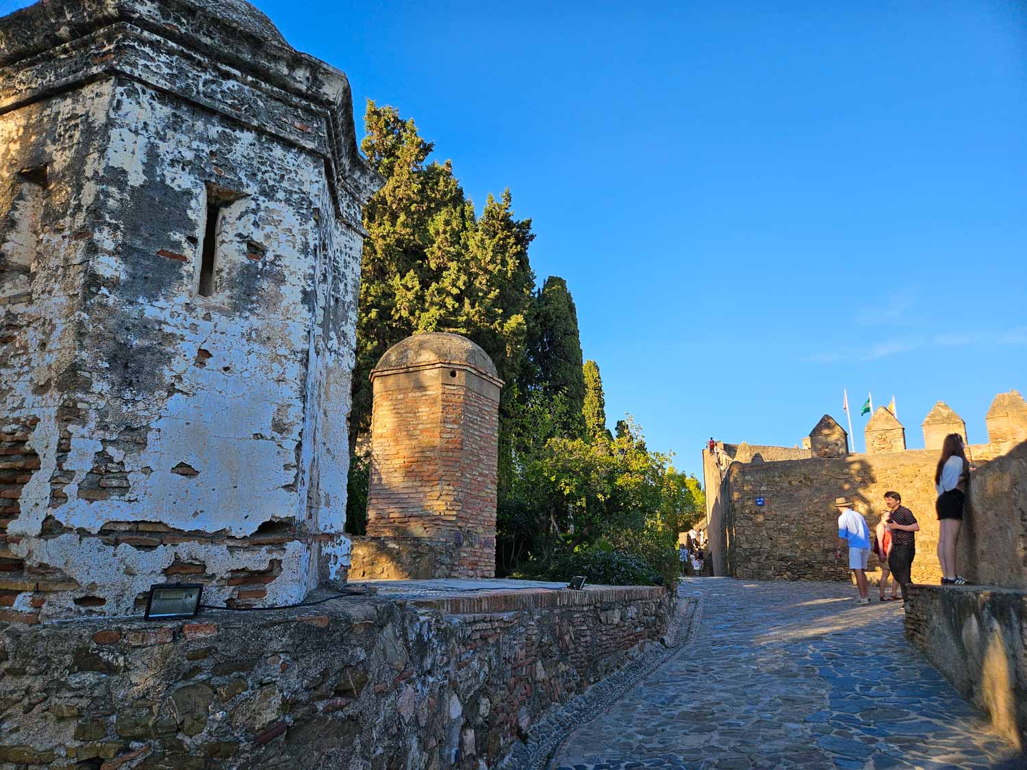 View of people by the walls inside Gibralfaro Castle - a visit is one of the best things to do in Malaga with kids