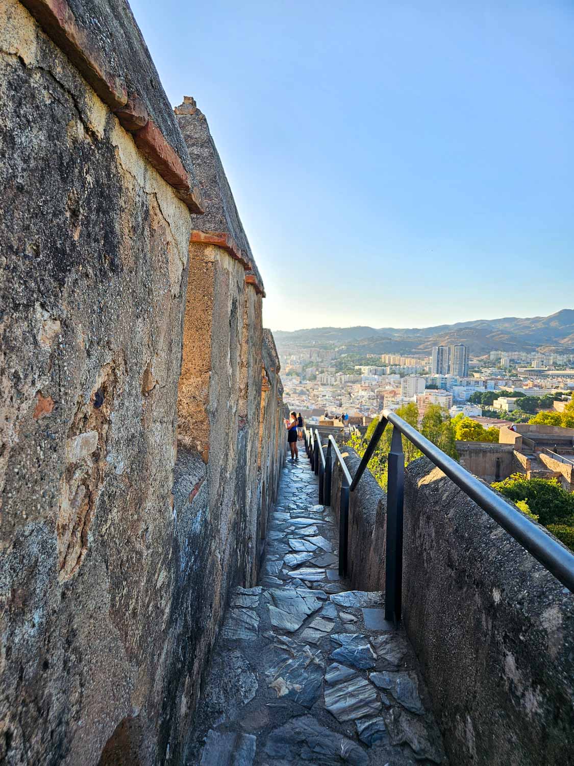 View of one of the narrow paths leading alongside the walls of Gibralfaro Castle in Malaga - a visit is one of the best things to do in Malaga with kids
