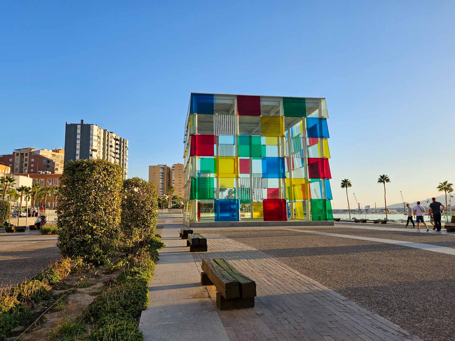View along the Muelle Uno waterfront to the multicoloured glass cube of the Pompidou Centre in Malaga - a visit is one of the many things to do in Malaga with kids