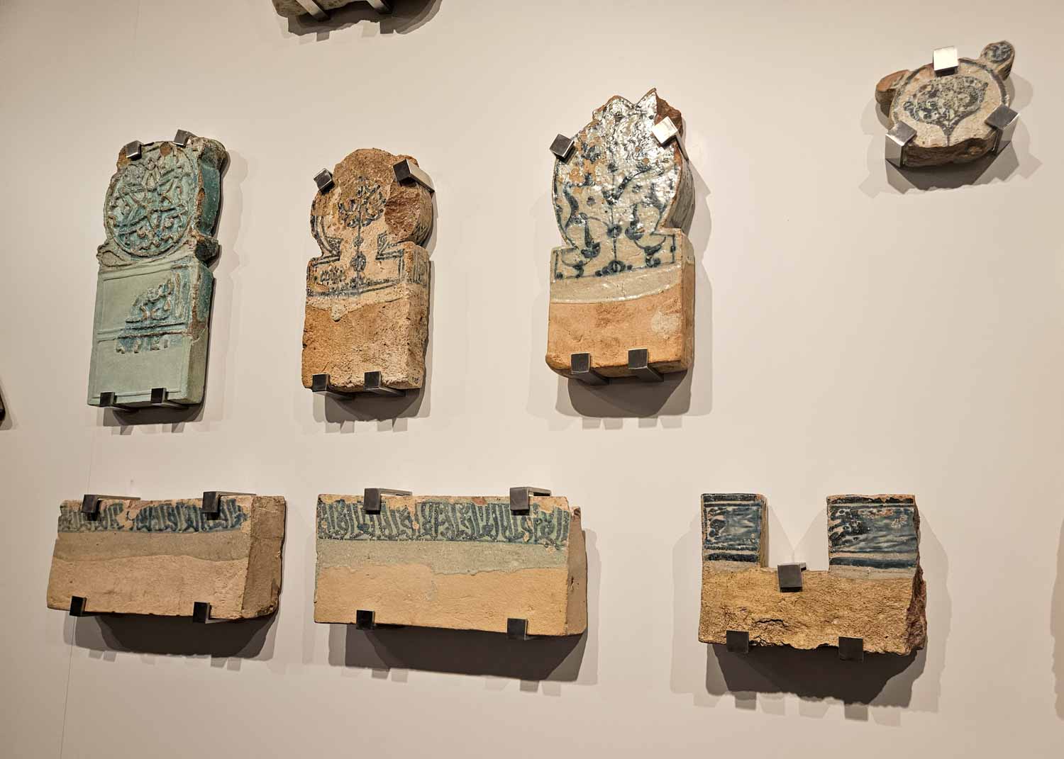 Pieces of historic Islamic tiles from the former Muslim kingdons which ruled the area in the Museum of Malaga during a visit to Malaga for families