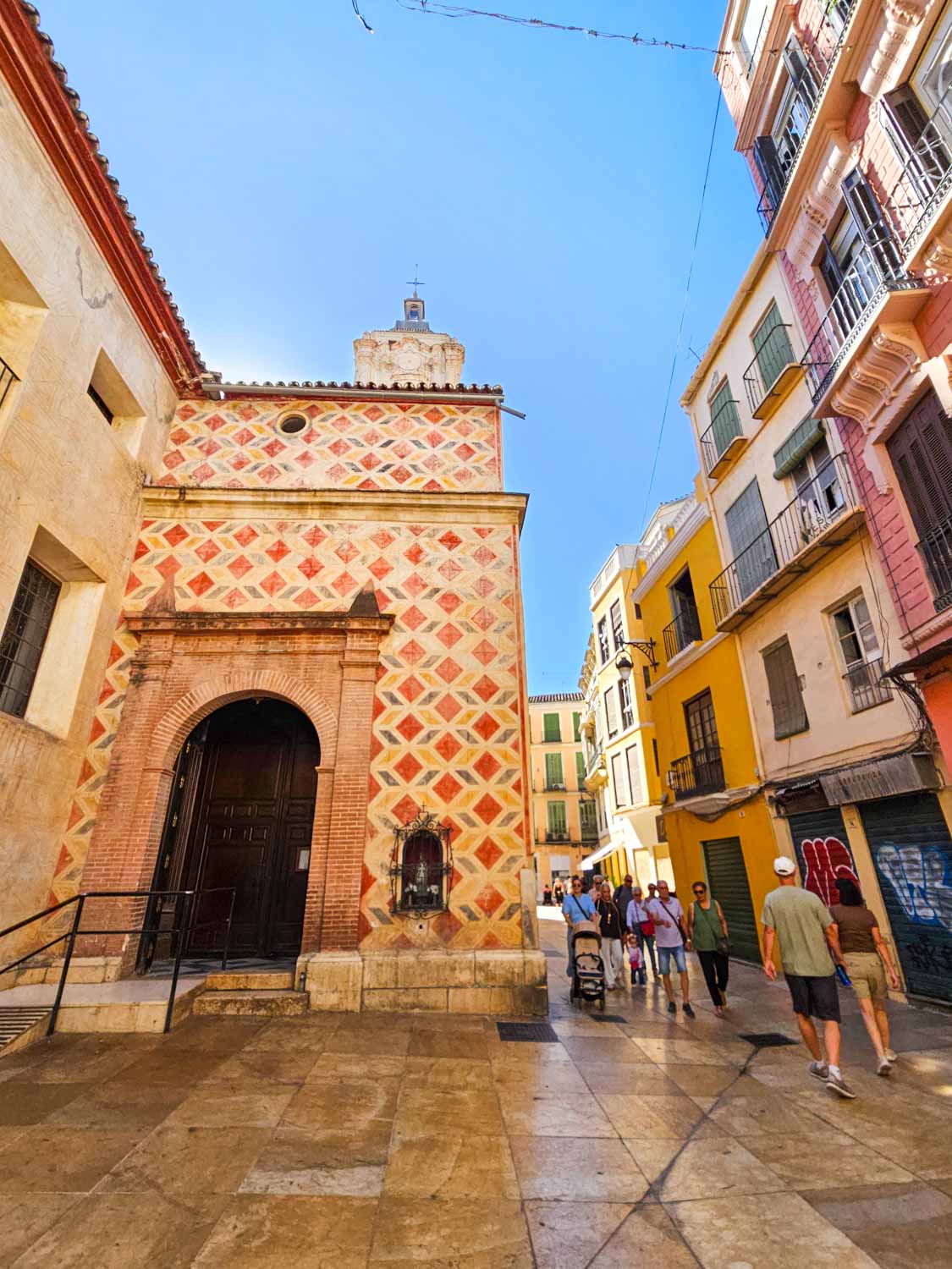 View of colourful painted buildings in the street of the old town - a walking tour or treasure hunt is a great way to explore Malaga with kids