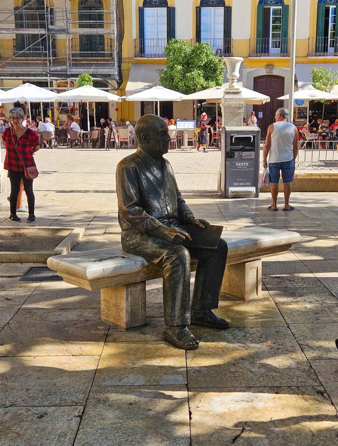 Statue of Picasso sitting on a bench in the square near the house where he was born - one of the quirky things to do in Malaga with kids