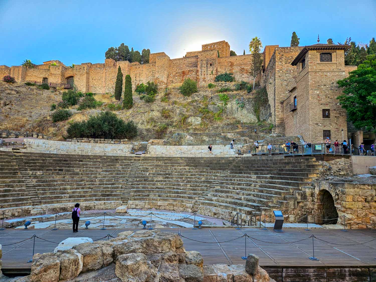 View up to the stone seats overlooking the old stage of the Roman theatre in Malaga - a visit is one of the best free things to do in Malaga with kids