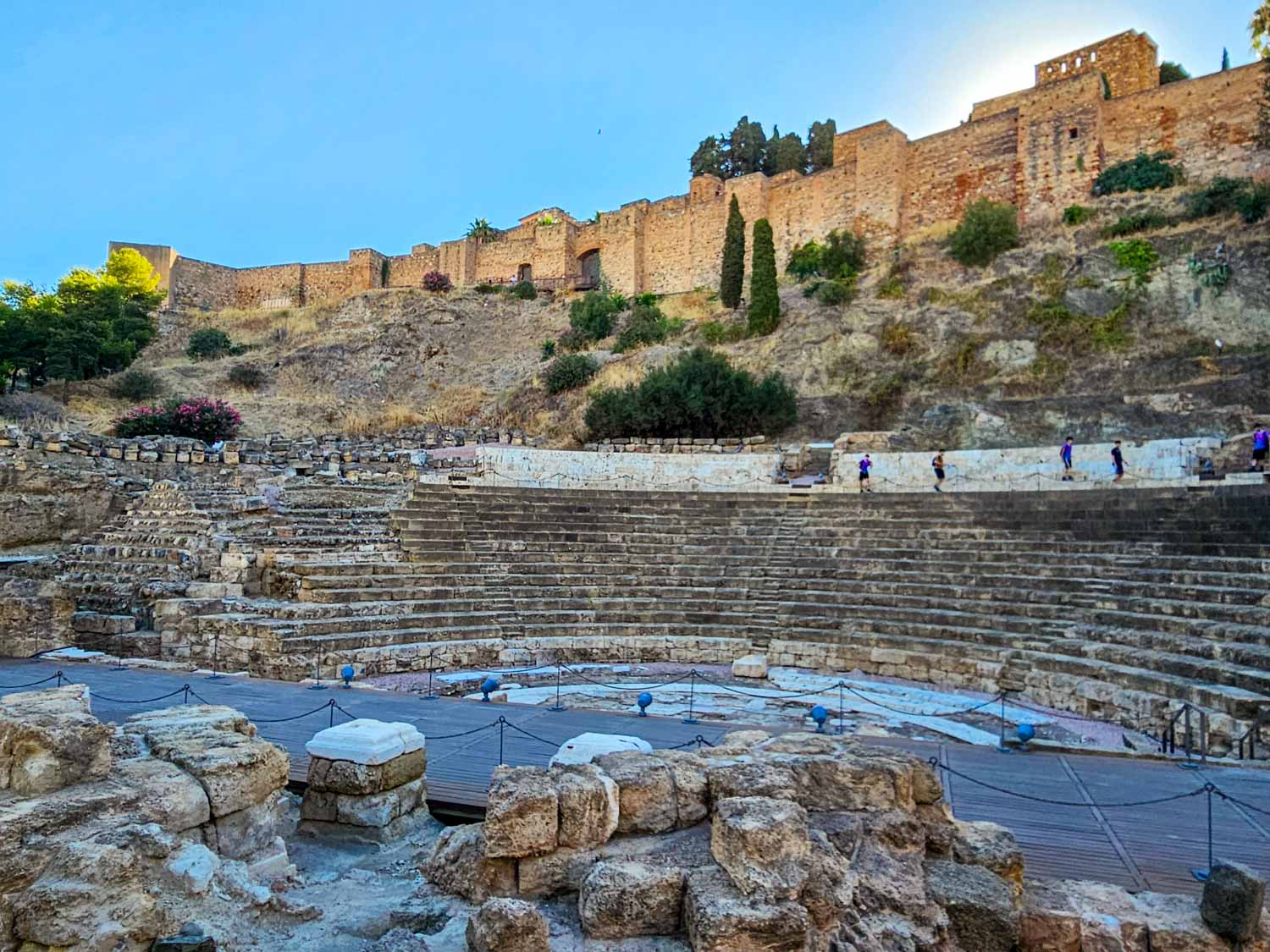 View up to the stone seats overlooking the old stage of the Roman theatre in Malaga - a visit is one of the best free things to do in Malaga with kids