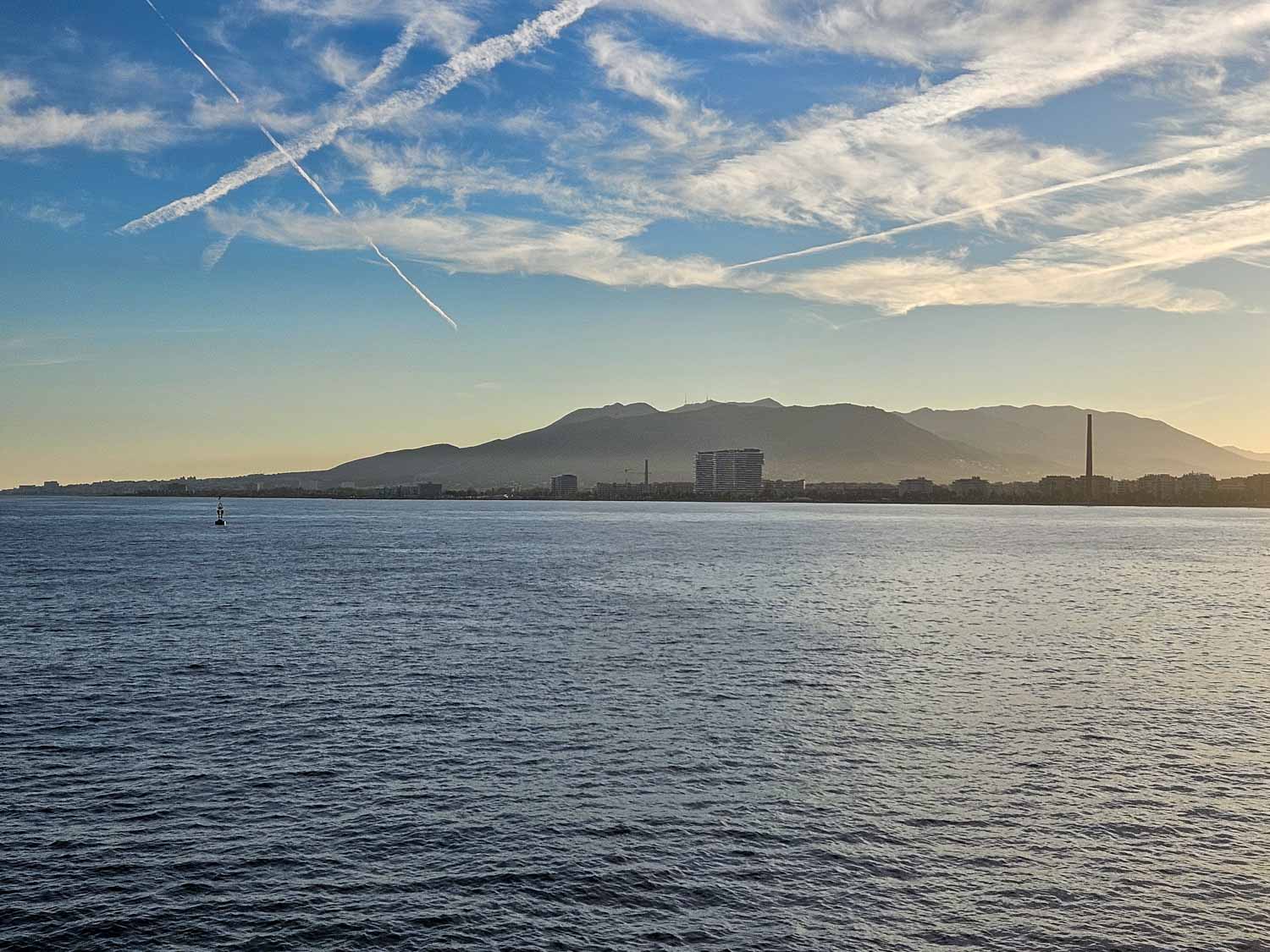 View across the harbour to the hills and buildings on the coast on a boat cruise - one of the best things to do in Malaga with kids